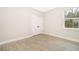 Bright bedroom with neutral walls, grey tile flooring, and natural light from a window at 2609 Sw 154Th Lane, Ocala, FL 34473