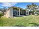 Beautiful backyard featuring a screened lanai, lush lawn, and seamless indoor-outdoor living at 280 Del Sol Ave, Davenport, FL 33837