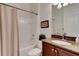 Well-lit bathroom showcasing a granite vanity, framed mirror, and a shower with curtain at 280 Del Sol Ave, Davenport, FL 33837