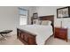 Bedroom featuring a wooden bed frame, side tables, and a window with blinds at 280 Del Sol Ave, Davenport, FL 33837