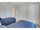 Bright bedroom featuring twin beds with patterned blue bedspreads and white trim at 280 Del Sol Ave, Davenport, FL 33837