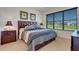 Well-lit bedroom featuring a wood headboard, patterned bedding, and side tables at 280 Del Sol Ave, Davenport, FL 33837