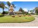 Beautiful community entrance with a water feature and colorful flowers at 280 Del Sol Ave, Davenport, FL 33837