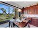 Bright dining area with large glass doors and views of the manicured backyard and pond at 280 Del Sol Ave, Davenport, FL 33837