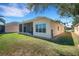 Stunning home exterior with a screened lanai, a well-maintained lawn and stone landscaping at 280 Del Sol Ave, Davenport, FL 33837