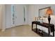 Bright foyer featuring tile flooring, console table with decorative accents, and a sidelight front door at 280 Del Sol Ave, Davenport, FL 33837