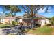 Beautiful single-story home with mature trees, landscaped yard, and brick driveway at 280 Del Sol Ave, Davenport, FL 33837