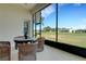 Screened-in lanai offers picturesque views of the lush golf course and community at 280 Del Sol Ave, Davenport, FL 33837