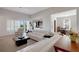 Bright living room with tile floors, white leather sofas and open access to other living spaces at 280 Del Sol Ave, Davenport, FL 33837