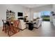 Inviting living room with white couches, a bar table, and sliding glass doors at 280 Del Sol Ave, Davenport, FL 33837