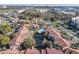 Stunning aerial view of community featuring tile roofs, mature trees, and a sparkling blue community pool with pond at 3004 Parkway Blvd # 202, Kissimmee, FL 34747