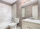 This bathroom features marble tile surround, single sink vanity and is efficiently laid out at 3004 Parkway Blvd # 202, Kissimmee, FL 34747