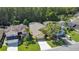 Aerial view of a home with a well-maintained lawn, adjacent to neighboring homes, and lush green landscaping at 3048 Stillwater Dr, Kissimmee, FL 34743