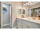 Bathroom featuring dual sinks with white cabinets and round window at 3048 Stillwater Dr, Kissimmee, FL 34743