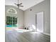 Light-filled living room with sliding glass doors leading to the pool, and neutral gray walls at 3048 Stillwater Dr, Kissimmee, FL 34743