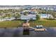 Aerial view showcases a lake with a gazebo dock, complete with kayaks, and a clubhouse with a pool area at 3120 Paradox Cir # 204, Kissimmee, FL 34746