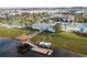 Aerial view showcases a lake with a gazebo dock, complete with kayaks, and a clubhouse with a pool area at 3120 Paradox Cir # 204, Kissimmee, FL 34746