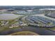 Aerial shot showcases a neighborhood with houses surrounding a lake and community amenity at 3120 Paradox Cir # 204, Kissimmee, FL 34746