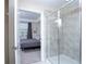 Bathroom featuring a gray tiled shower and partial view to an adjacent bedroom at 3120 Paradox Cir # 204, Kissimmee, FL 34746