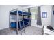 Cozy bedroom features a bunk bed with blue bedding, gray curtains, a window, and white walls at 3120 Paradox Cir # 204, Kissimmee, FL 34746