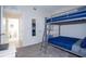 Bedroom featuring a bunk bed, mirror, gray carpet, and view to the bathroom at 3120 Paradox Cir # 204, Kissimmee, FL 34746