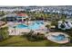 Aerial view showcases a pool with beach entry surrounded by lounge chairs at 3120 Paradox Cir # 204, Kissimmee, FL 34746