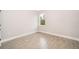 Minimalist bedroom featuring tile floors, neutral walls, and a window offering natural light at 3177 Sw 127Th Street, Ocala, FL 34473