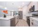 Bright kitchen with stainless steel appliances, island, pendant lighting, and stylish tile flooring at 3177 Sw 127Th Street, Ocala, FL 34473