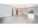 Open-concept living room with light-colored tile floors, and a view of the modern kitchen at 3177 Sw 127Th Street, Ocala, FL 34473