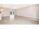 Bright living room with tile flooring, neutral walls, and a sliding glass door to the outside at 3177 Sw 127Th Street, Ocala, FL 34473