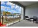 Balcony view overlooking the community pool, palm trees, and blue sky at 3180 Paradoux Circle # 205, Kissimmee, FL 34746