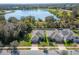 An aerial view of a well-maintained house with a lake in the background at 3204 Wauseon Dr, St Cloud, FL 34772