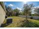 Well-maintained backyard featuring a lush lawn and mature trees, perfect for outdoor enjoyment at 3204 Wauseon Dr, St Cloud, FL 34772