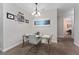 Dining area featuring modern chandelier lighting and a glass table with seating for four at 3204 Wauseon Dr, St Cloud, FL 34772