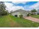 Side exterior of home with garage, side yard with green lawn at 3204 Wauseon Dr, St Cloud, FL 34772