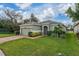 Beautiful one-story home with green lawn and plants in the front at 3204 Wauseon Dr, St Cloud, FL 34772