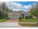 Charming single-story home featuring a two-car garage and a well-manicured lawn with mature landscaping at 3204 Wauseon Dr, St Cloud, FL 34772