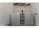 Functional laundry room with a washer, dryer, and shelving for storage at 3204 Wauseon Dr, St Cloud, FL 34772