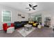 Inviting living room with comfortable seating, a ceiling fan, and bright natural light from large windows at 3204 Wauseon Dr, St Cloud, FL 34772