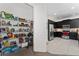 Walk-in pantry showcasing ample shelving, and organization, adjacent to the kitchen with stainless appliances at 3204 Wauseon Dr, St Cloud, FL 34772