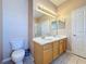 Bathroom with a double sink vanity with tile floor and vanity lighting at 331 Henley Cir, Davenport, FL 33896