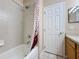 Bathroom with neutral tiling featuring shower with decorative shower curtain and toilet at 331 Henley Cir, Davenport, FL 33896