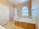 Bathroom featuring tub, glass shower, and vanity with a window at 331 Henley Cir, Davenport, FL 33896