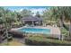 Community pool featuring clear blue water, lounge chairs, and covered seating area at 331 Henley Cir, Davenport, FL 33896