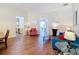 Comfortable living room with hardwood floors, neutral walls, a sofa, an armchair, and accent tables at 331 Henley Cir, Davenport, FL 33896