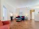 Cozy living room with hardwood floors, a blue sofa, a side chair, and decorative accents at 331 Henley Cir, Davenport, FL 33896