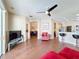 Bright living room with wood-look tile flooring, ceiling fan, and an open layout to the kitchen and other living spaces at 331 Henley Cir, Davenport, FL 33896