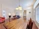 Open-concept living room featuring wood floors, a dining table, and a glimpse of the seating area at 331 Henley Cir, Davenport, FL 33896