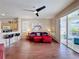 Bright living room featuring a red sofa, ceiling fan, and sliding door to the lanai at 331 Henley Cir, Davenport, FL 33896