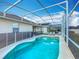 Beautiful in-ground pool with screened enclosure, lounge chairs, and landscaped surroundings at 331 Henley Cir, Davenport, FL 33896